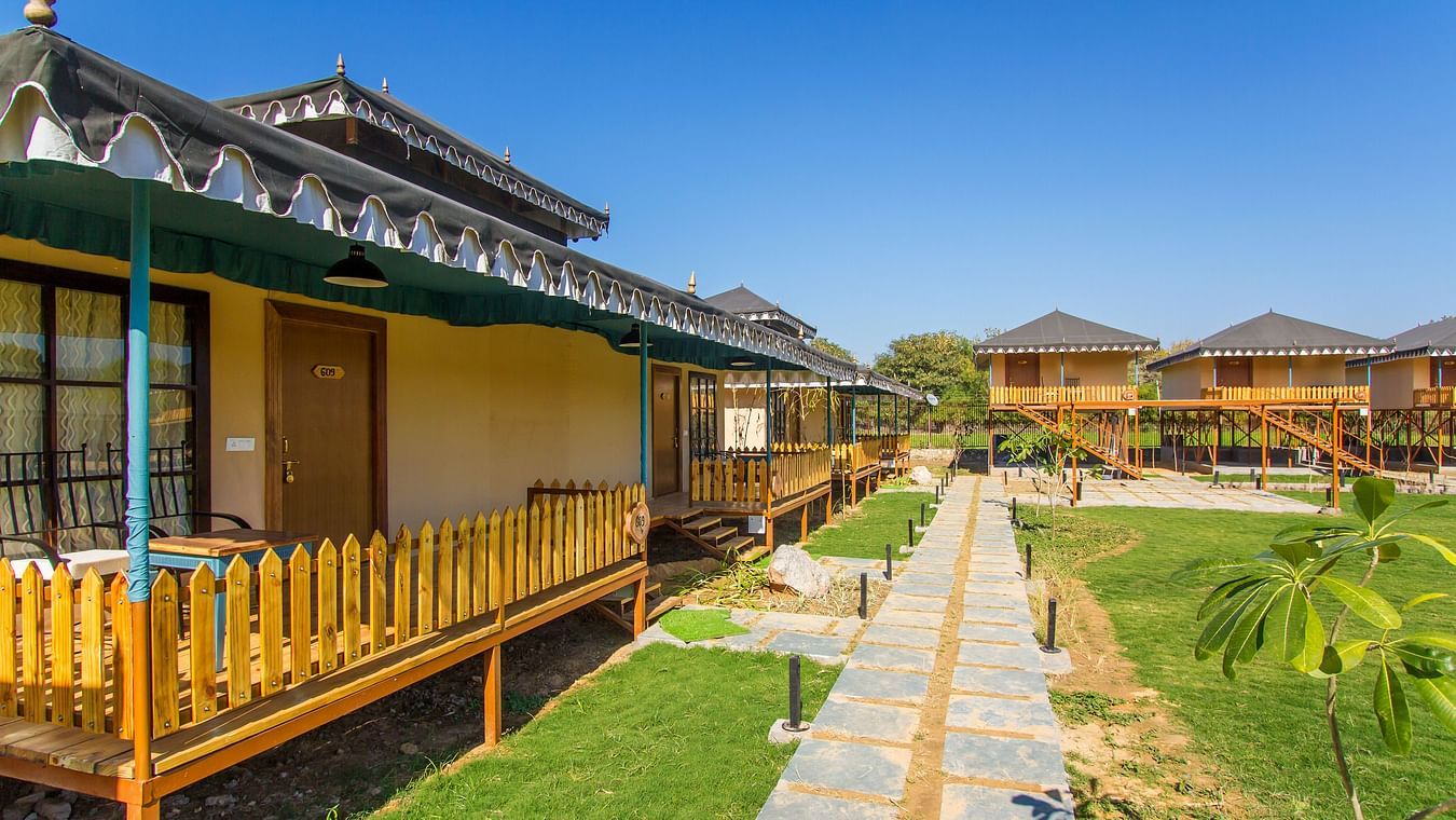 view of other cottages from the attached balcony of a room in Ranthambore at The Baagh Ananta Elite