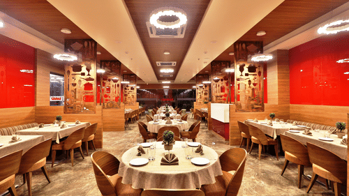 Seating arrangements inside the Kamats Restaurant with modern interiors - VITS Devbhumi, Dwarka