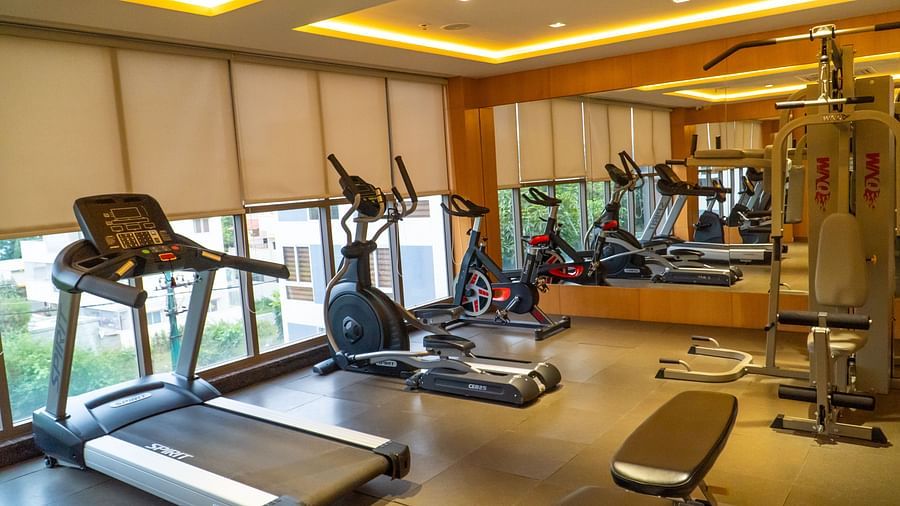 Exercise equipment in a room with large windows.