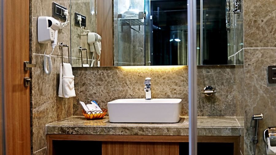 The sink area of the Executive room's Washroom with a mirror - VITS Devbhumi, Dwarka
