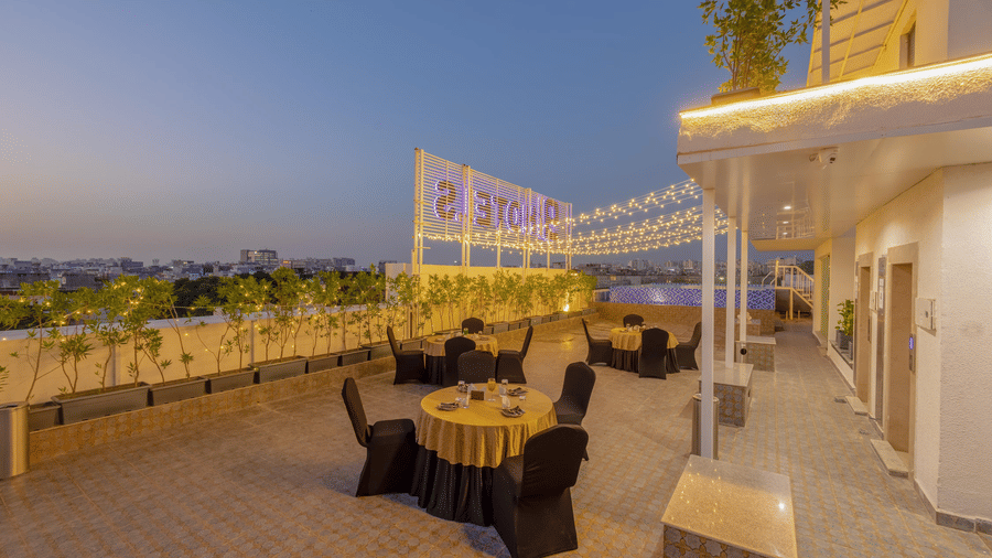 Corner view of the Infinity Blue Rooftop at Hotel 91 Privé, Gurugram, overlooking the beautiful city skyline under the late evening skies.