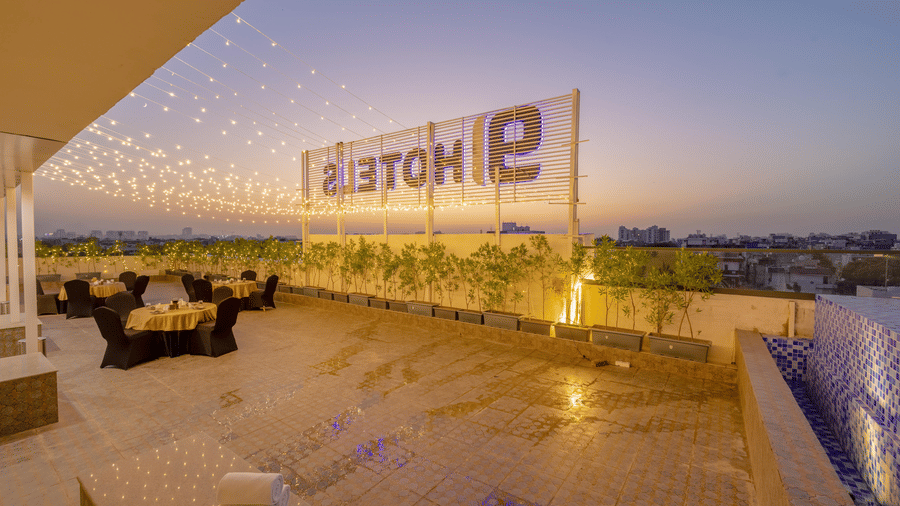 The Infinity Blue Rooftop decorated with fairy lights and warm exterior lighting during the late evening hours at Hotel 91 Privé, Gurugram.