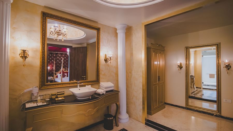 Image of a washroom with a sink and a large glass above it at Rajasthali Resort & Spa Jaipur.