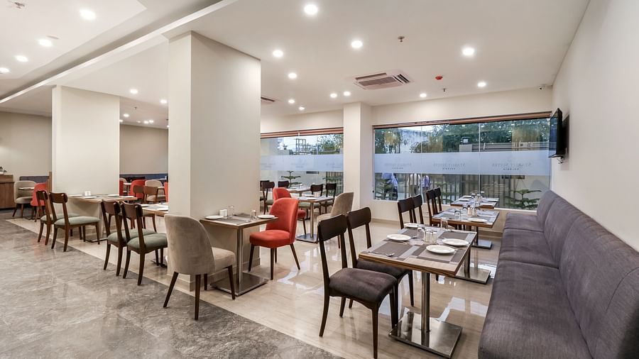 Overview of the seating arrangement inside Gourmet Restaurant - Starlit Suites Newtown, Kolkata