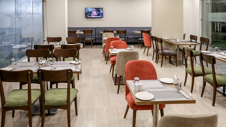 Seating arrangement inside Gourmet - Starlit Suites Newtown, Kolkata