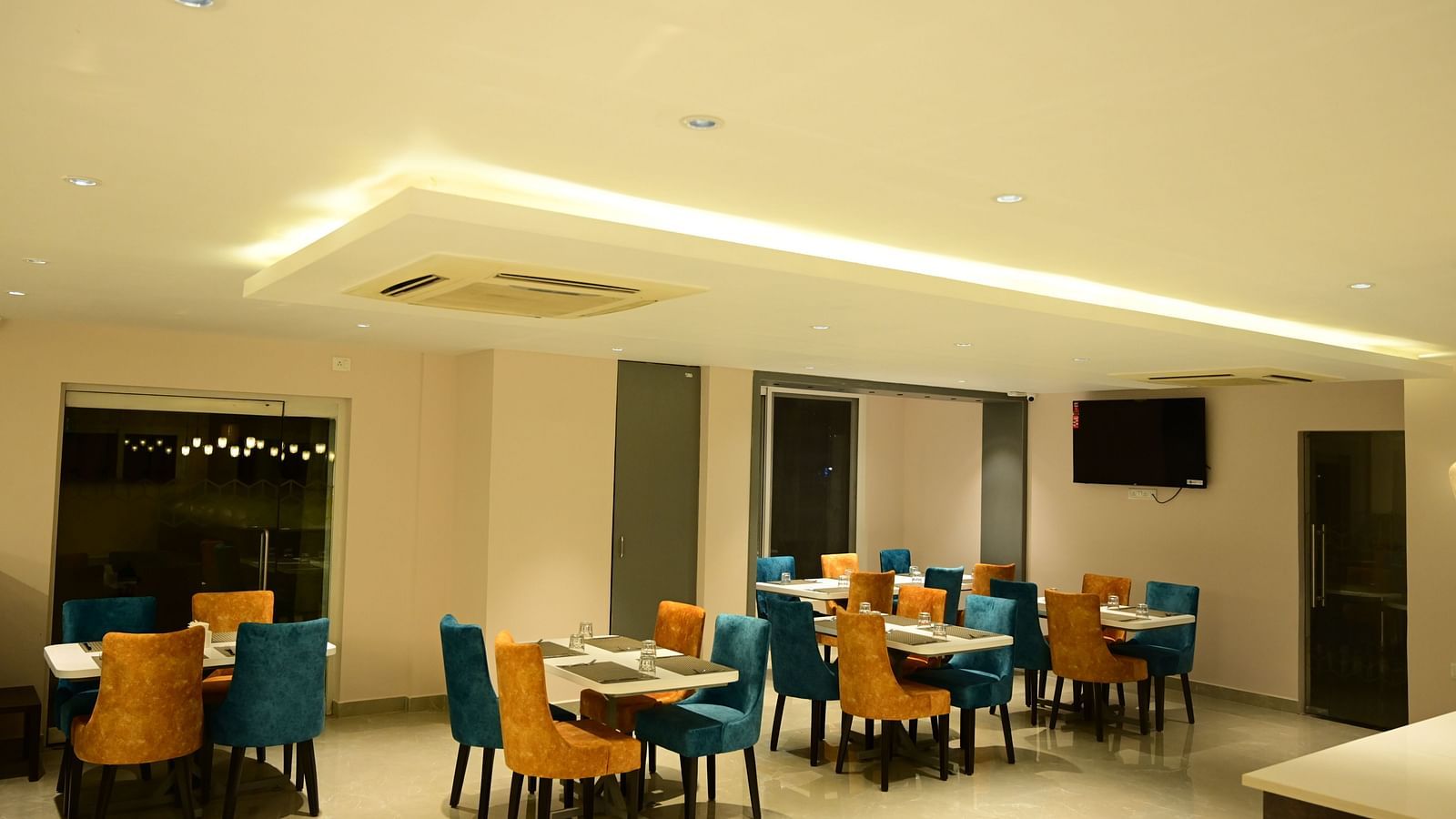 Blue and Yellow coloured chairs at the restaurant at Sterling Keys by TGI in Bnagalore