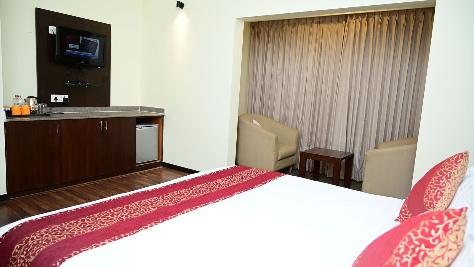 Side view of a double bed and a small cabinet in the Executive Suite at Sterling Keys by TGI