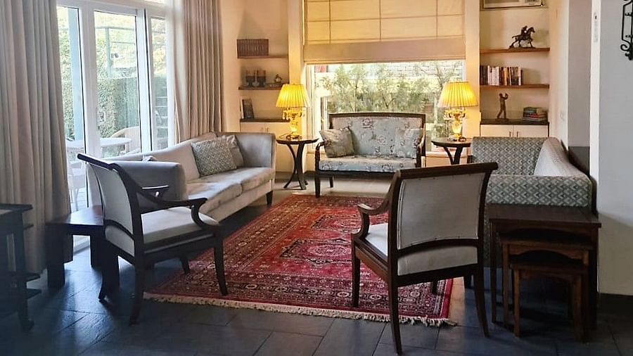 closer ciew of living room couch and interior decor with wide windows captured during day time - Lamrin Norwood Green Palampur2