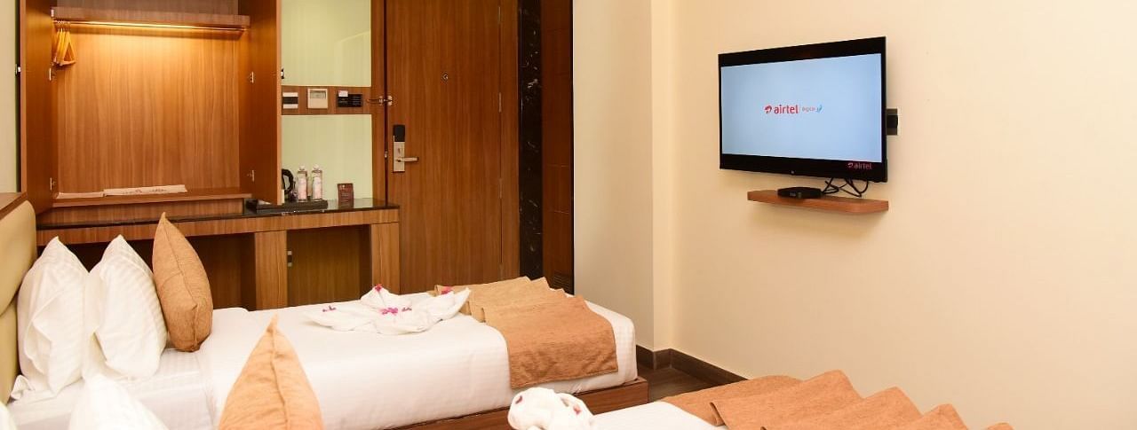 Twin beds with an LCD Television at TGI Felicity, Bangalore