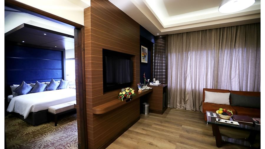 the bedroom and living area offered by Executive suite in Vizag
