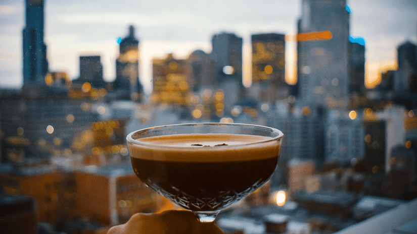 View of city in background with centre focus on the cocktail