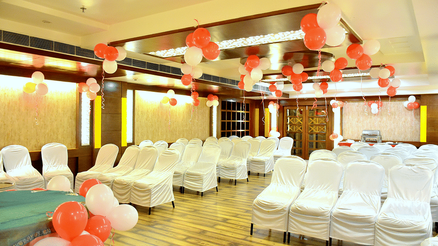A front view of chairs placed in a banquet hall decorated with ballons | Hotel City Inn, Varanasi