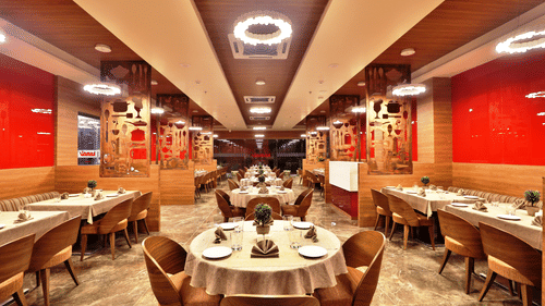 Seating arrangements inside the Kamats Restaurant with modern interiors - VITS Devbhumi, Dwarka