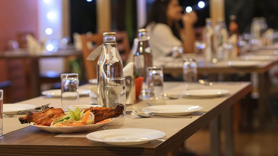 close up image of the dining table at blue charcoal with plates and cutlery set in Yashshree Karbari Resort & Spa, Yangang 