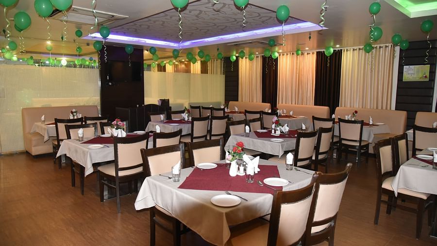 Image of the restaurant with dining spoace and ballons on the ceiling