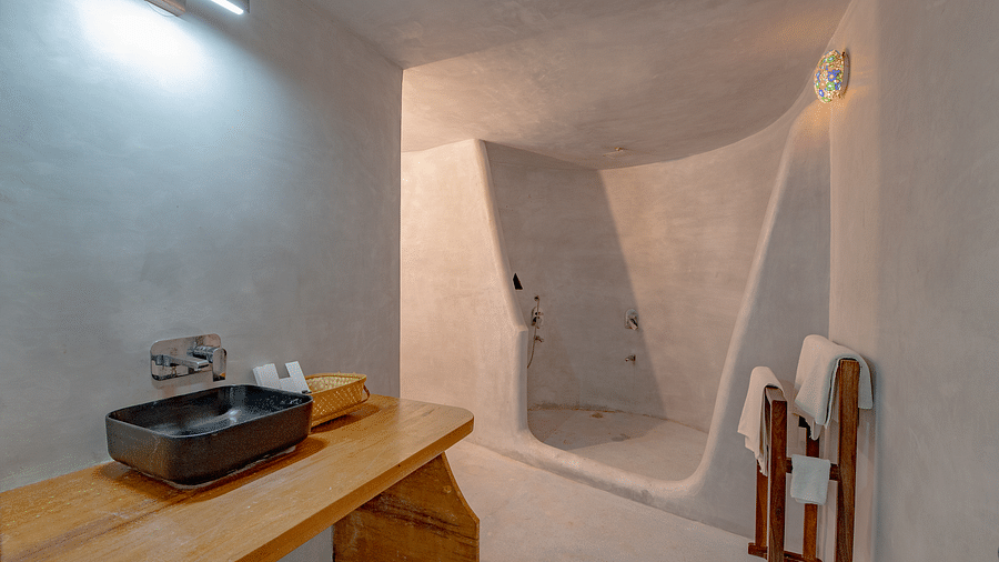 An image of a bathroom with cabinet and on top there is a sin and toilet utilities