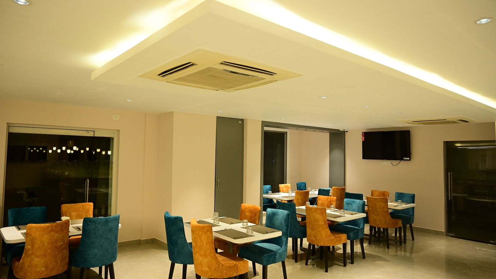 Blue and Yellow coloured chairs at the restaurant at Sterling Keys by TGI in Bnagalore