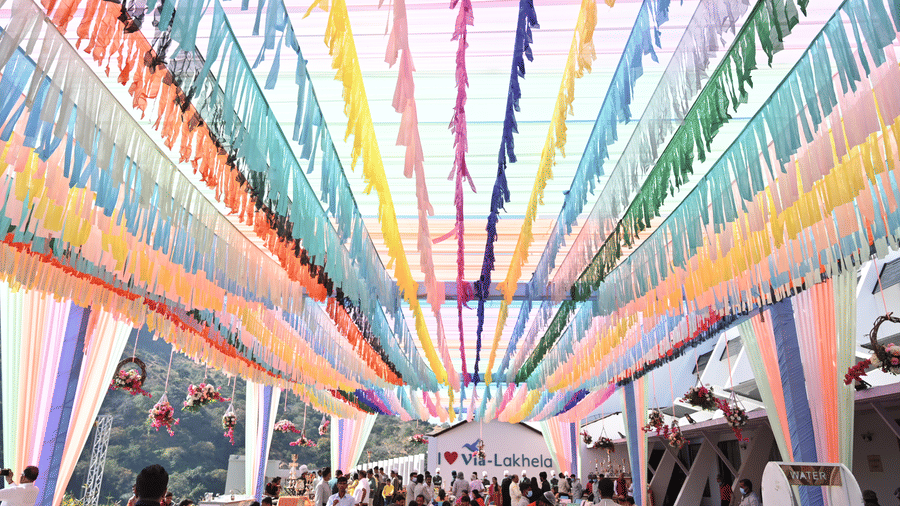 Colourful ribbons strung overhead with people gathered below - Via Lakhela Resort & Spa