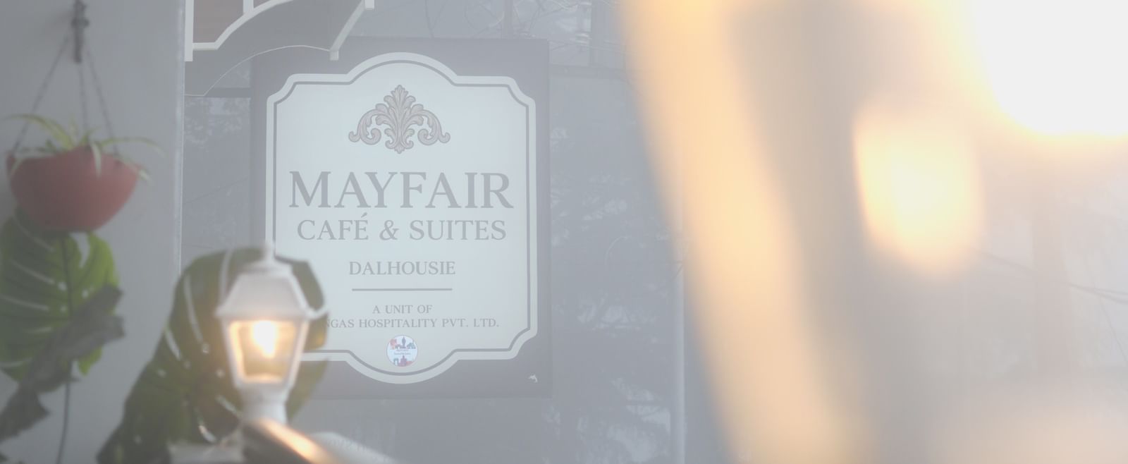 Close-up of a vintage lantern-style light fixture outside a suite - Mayfair Cafe & Suites, Dalhousie