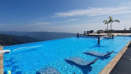 view of the turquoise water of Infinity pool at Cherrapunjee 