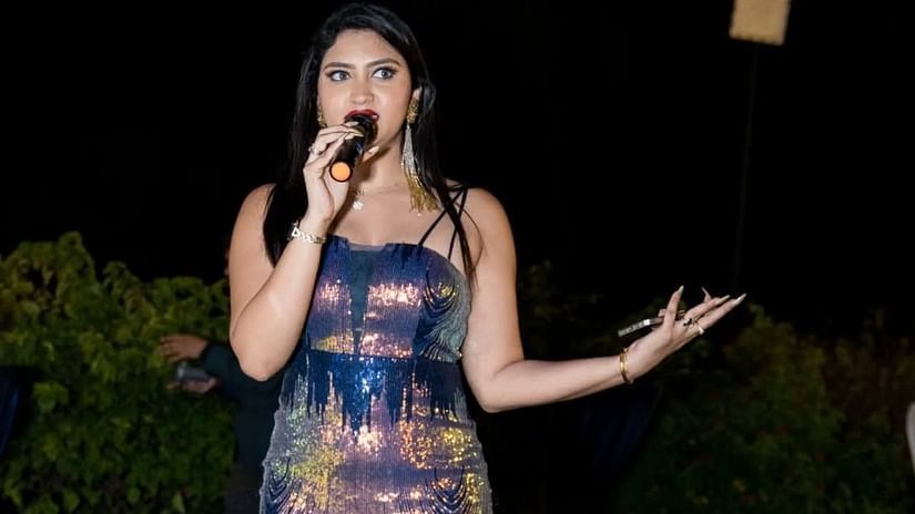 Woman performing on stage holding a microphone at Cloud9 Sarovar Premiere, Palolem Goa
