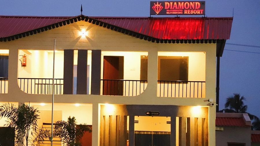 A close up image of the resort's exterior during a late evening with the sign board lit up in red - VITS Select Diamond Resort, Sasan Gir