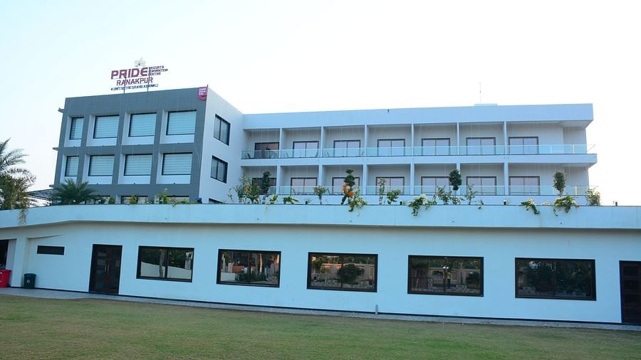 Pride Ranakpur Resort Convention Centre - exterior view of the Presidential banquet hall that has a lawn area with the property building in the background