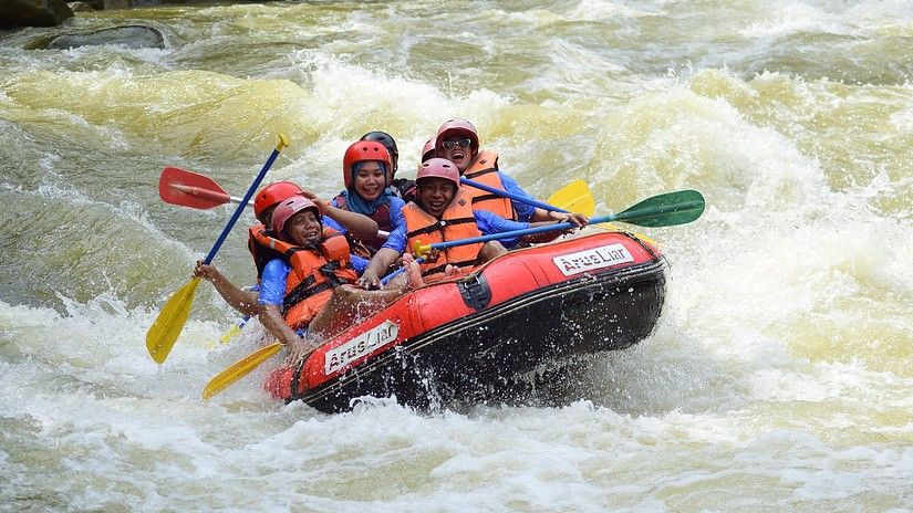 Group of people river rafting