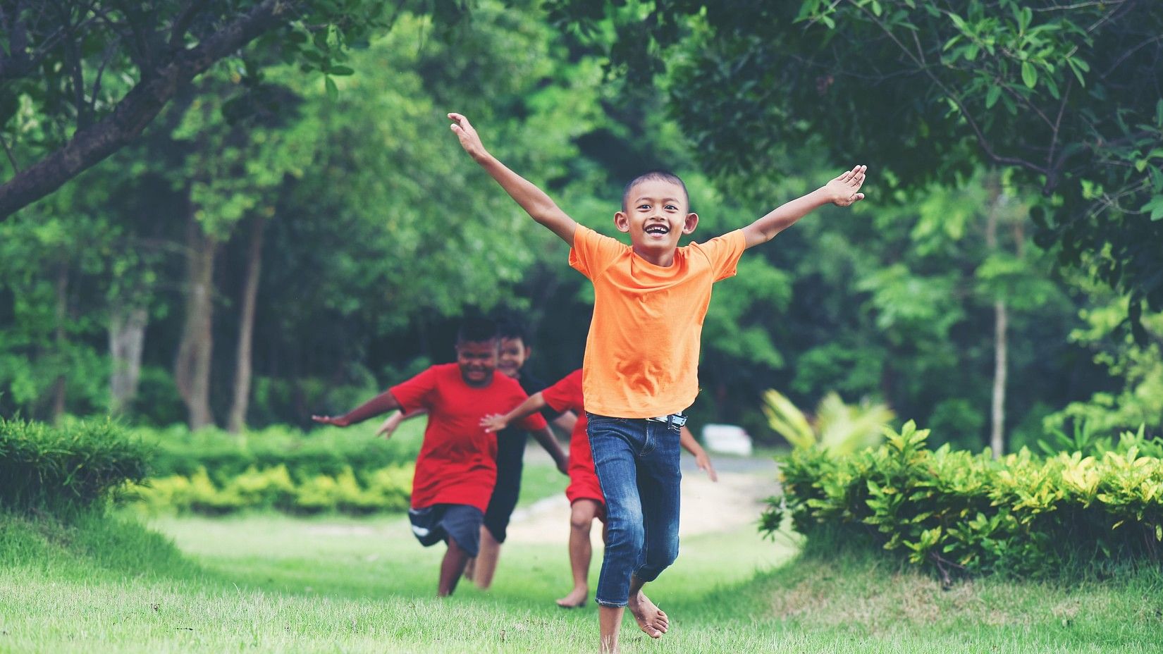 Children running in a field happily