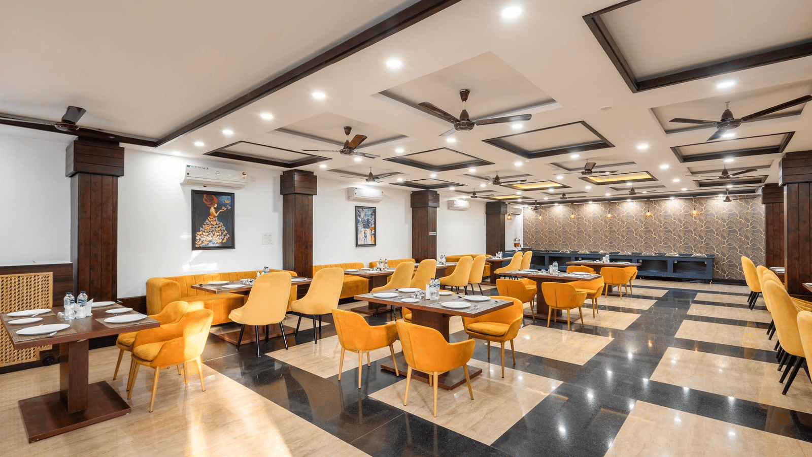 A dining hall with many tables and chairs and patterned floor tiles at Perfectstayz Premium Shanti Heritage, Haridwar