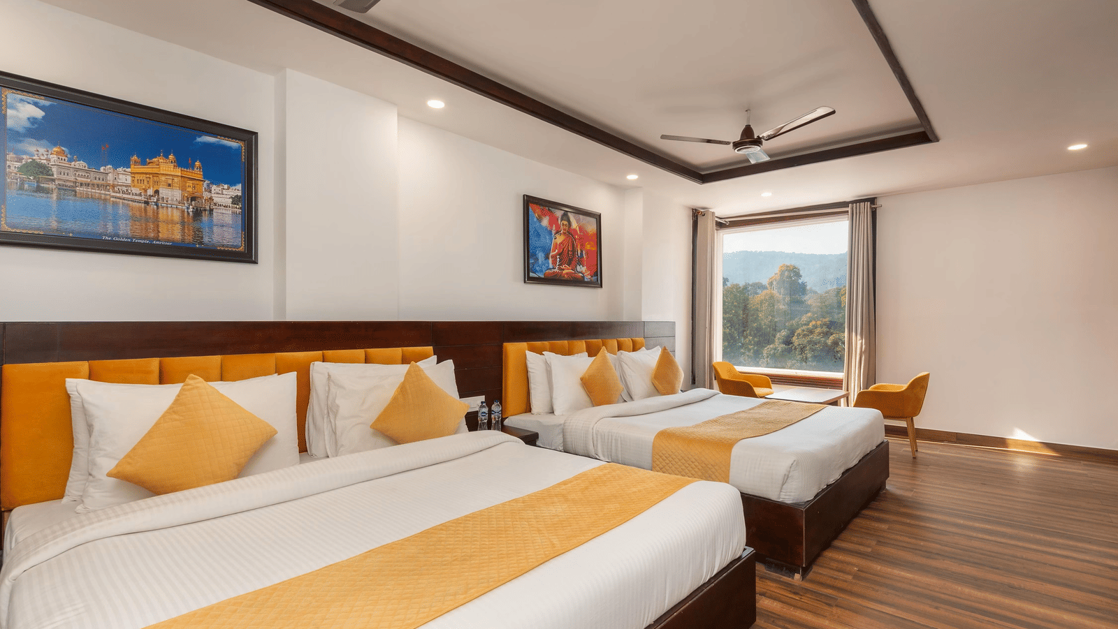 A hotel room with a king size bed, a small bed, a window, and wall decoration at Perfectstayz Premium Shanti Heritage, Haridwar.