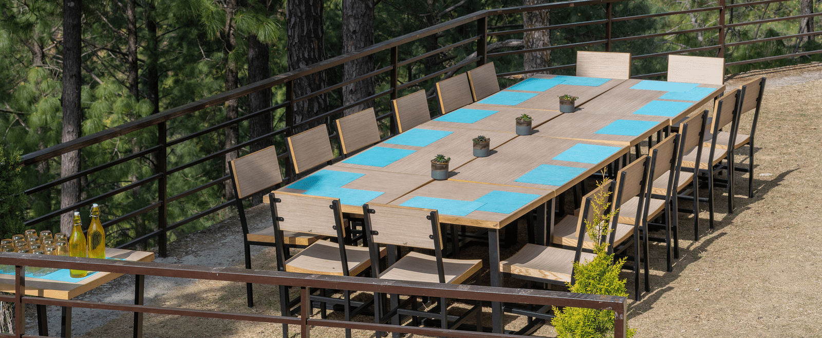 Lawn with neatly arranged chairs and a long table set up for an event at BluSalzz Escapade Resort, Lansdowne
