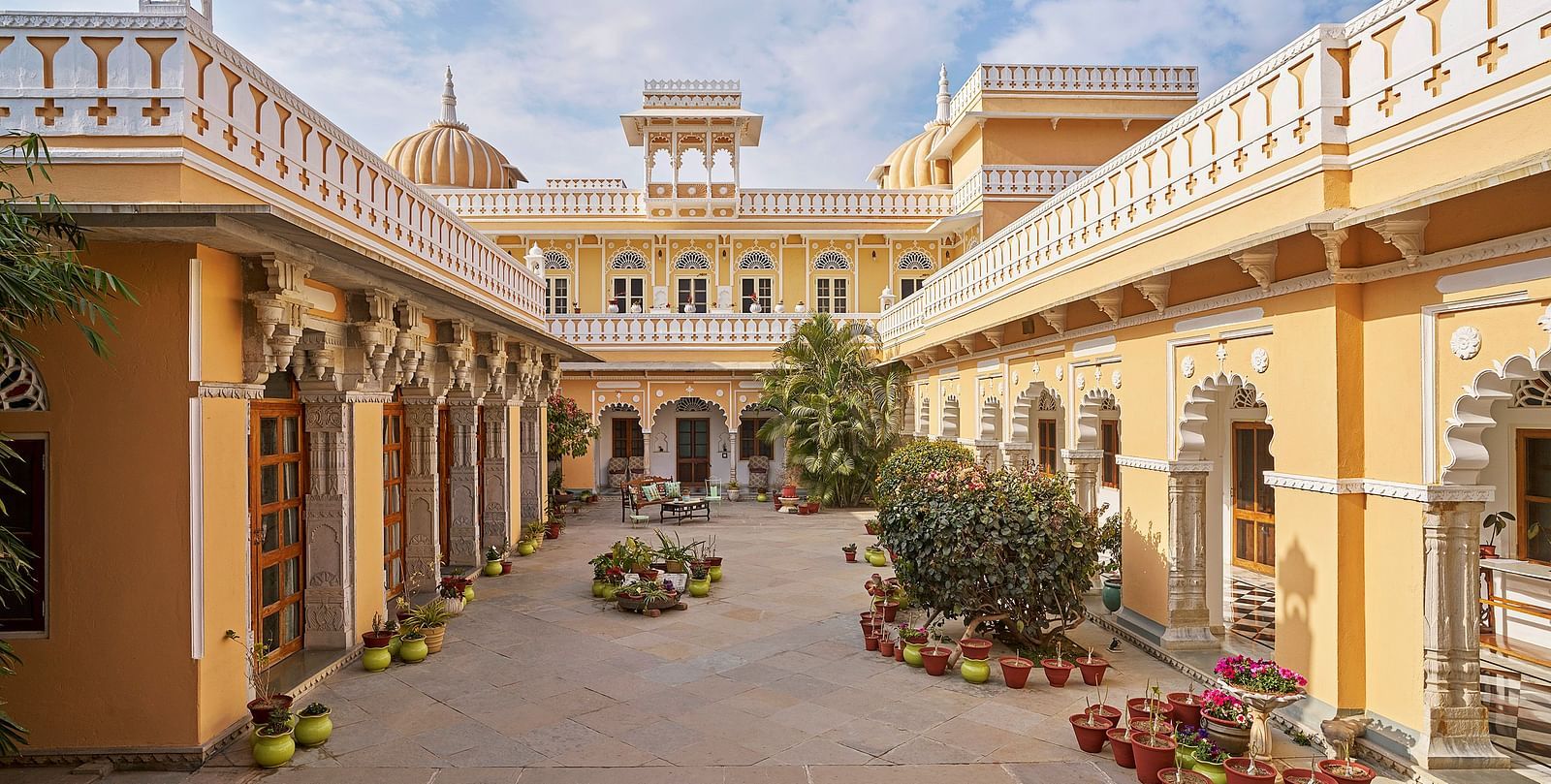 exterior image of dev shree, deogarh  with a beautiful sky with clouds in the background