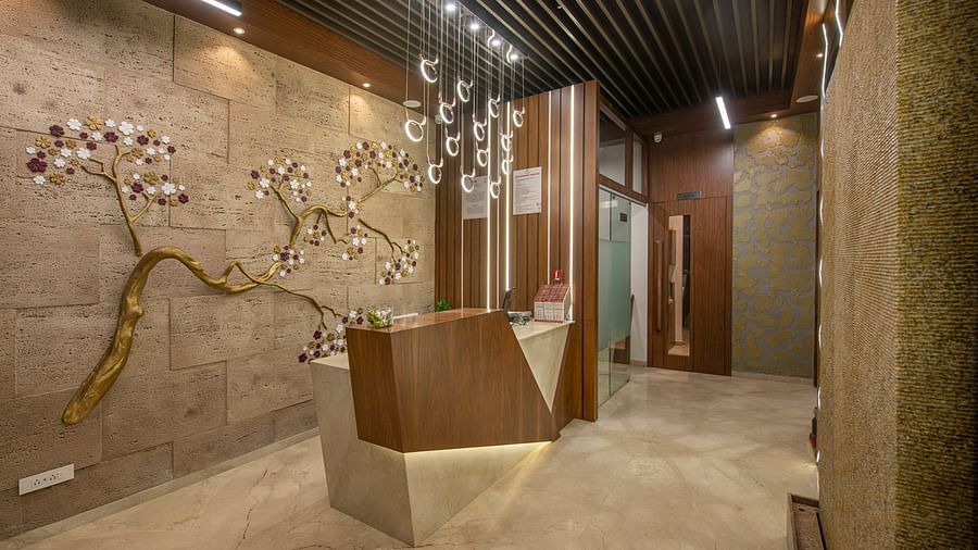An elegant hotel hallway with textured walls and subtle lighting - SK Lords Inn Ahmedabad