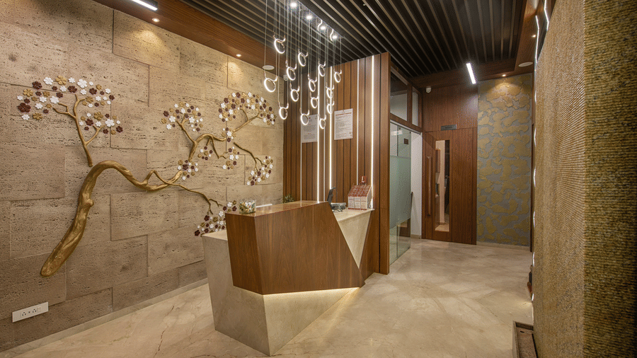 An elegant hotel hallway with textured walls and subtle lighting - SK Lords Inn Ahmedabad