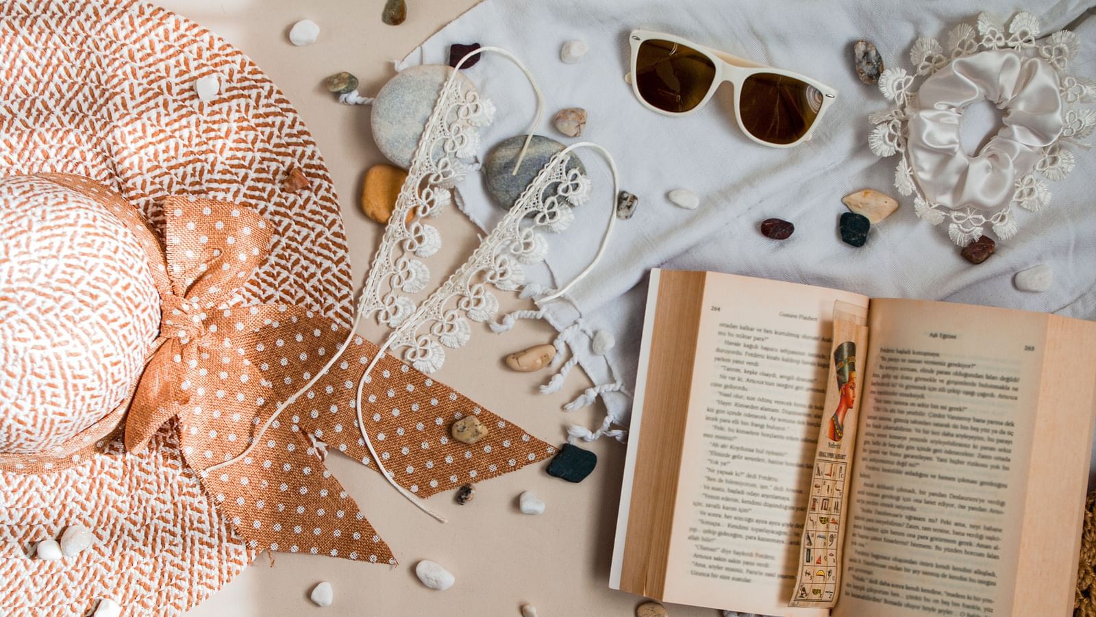 an open book next to many trinkets as seen from above