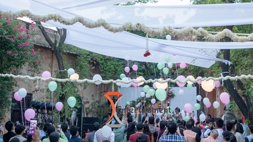 Hill Fort-Kesroli 14th Century Alwar - Image of an outdoor banquet space with a stage decorated using balloons and ribbons