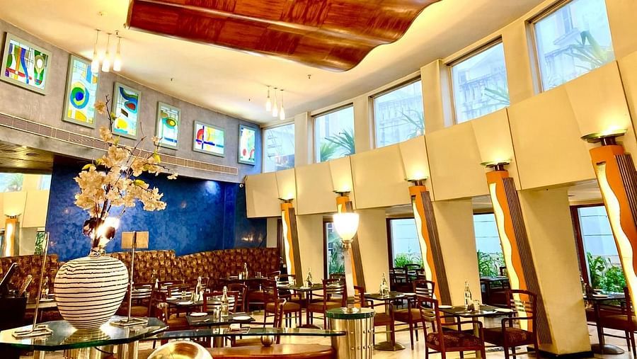 Elegant dining area with high ceilings and modern interiors at Aroma Multicuisine Restaurant at The Manohar, Hyderabad