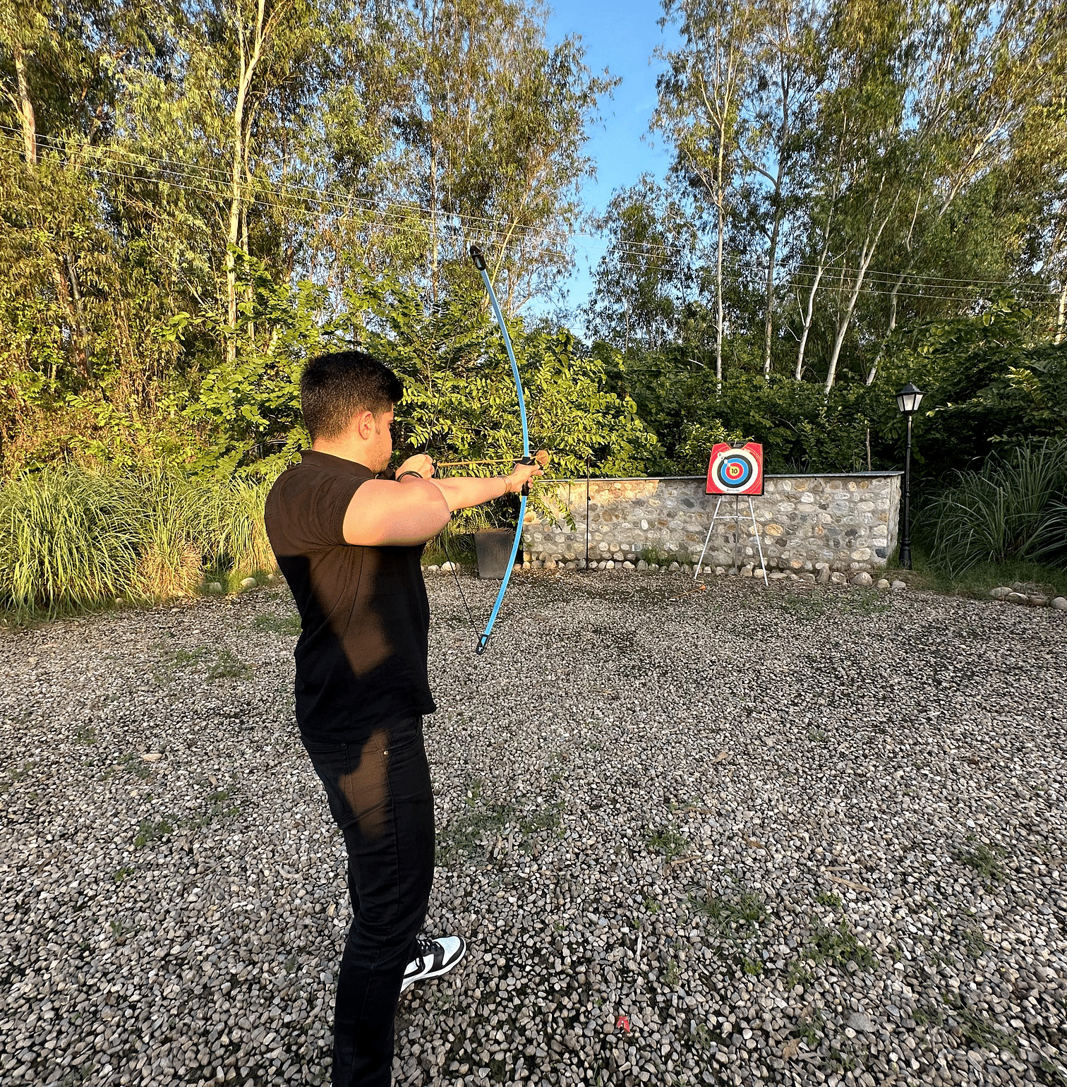 A person enjoying archery activity at our resort near Haridwar - Aalia Jungle Resort & Spa