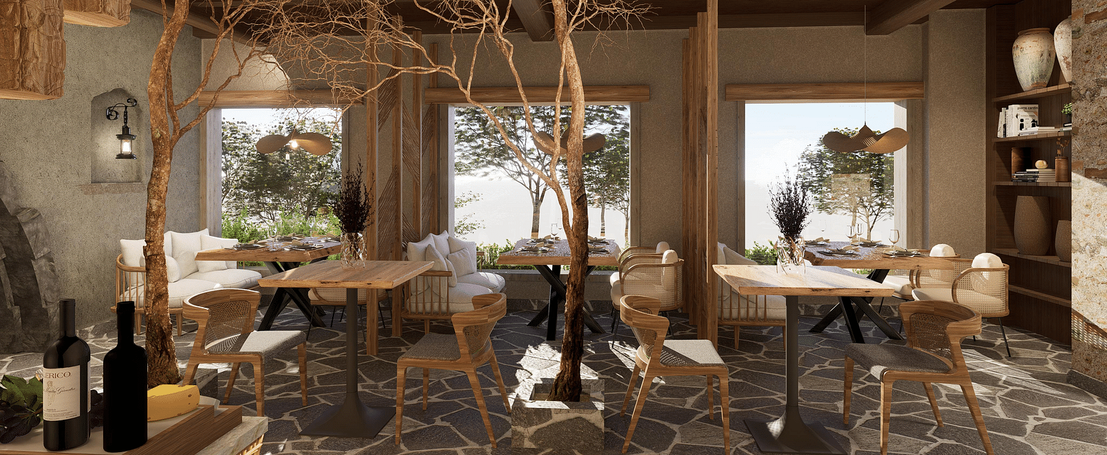 Side view of the restaurant at The Evren, Vagator, with arranged tables, chairs, and windows overlooking greenery.