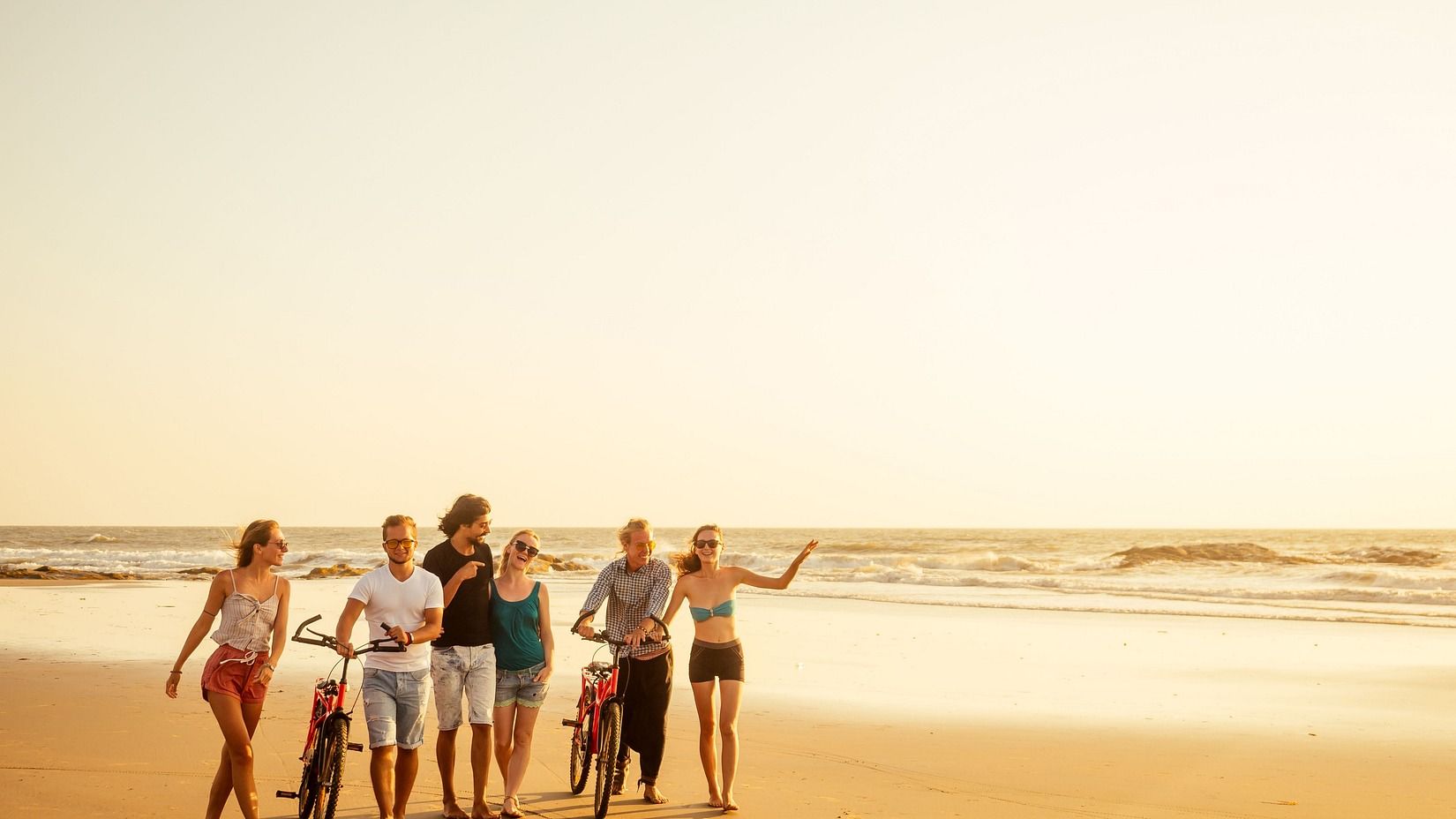 A group of people enjoying the outdoors on the beach.