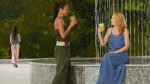 two women drinking juice