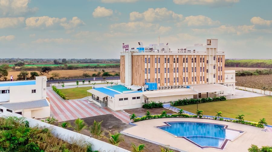 bird's eye view of The Orchid Hotel, Jamnagar with evening sky in the background