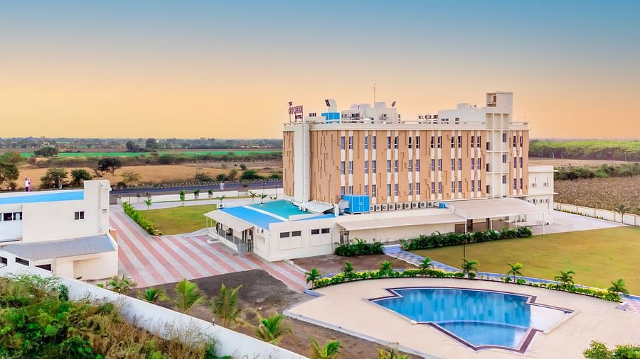 bird's eye view of The Orchid Hotel, Jamnagar with evening sky in the background