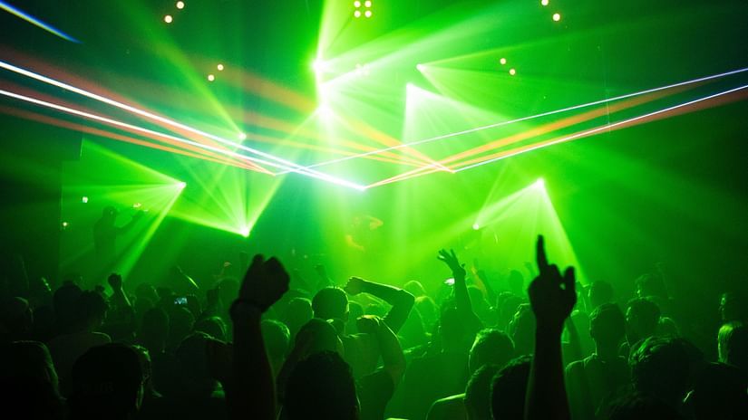 a party with neon lights where people are dancing the night away.