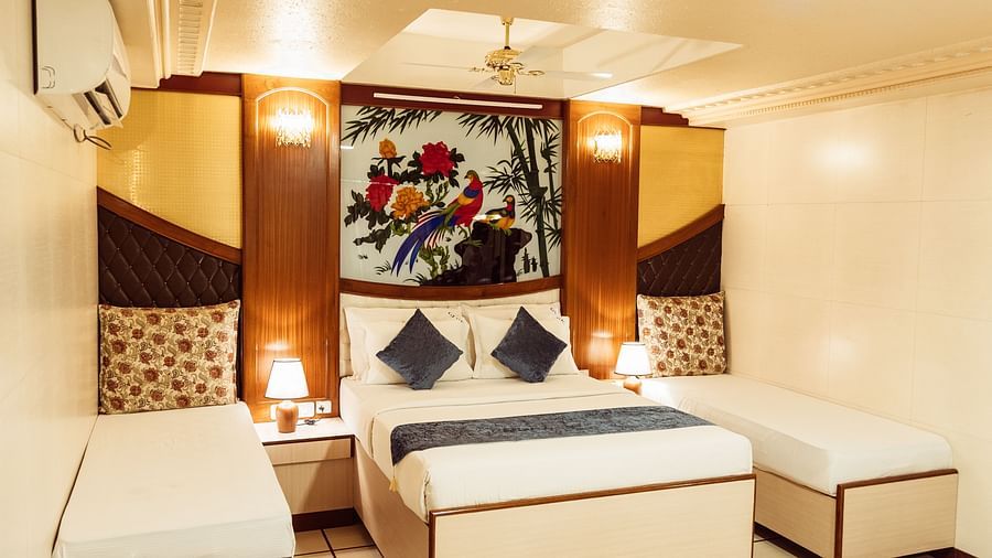 image featuring a double bed along with twin beds besides it at The Grand Krishna Rooms, Bengaluru