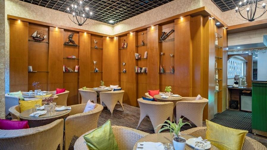 Restaurant setup with food counters and seating at Golden Tulip, Udaipur.