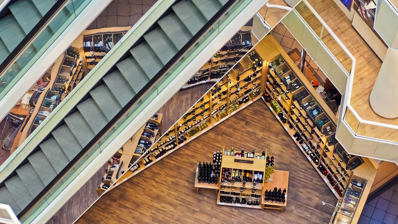 A view from the top of the bottom of a shopping mall taken from the top.