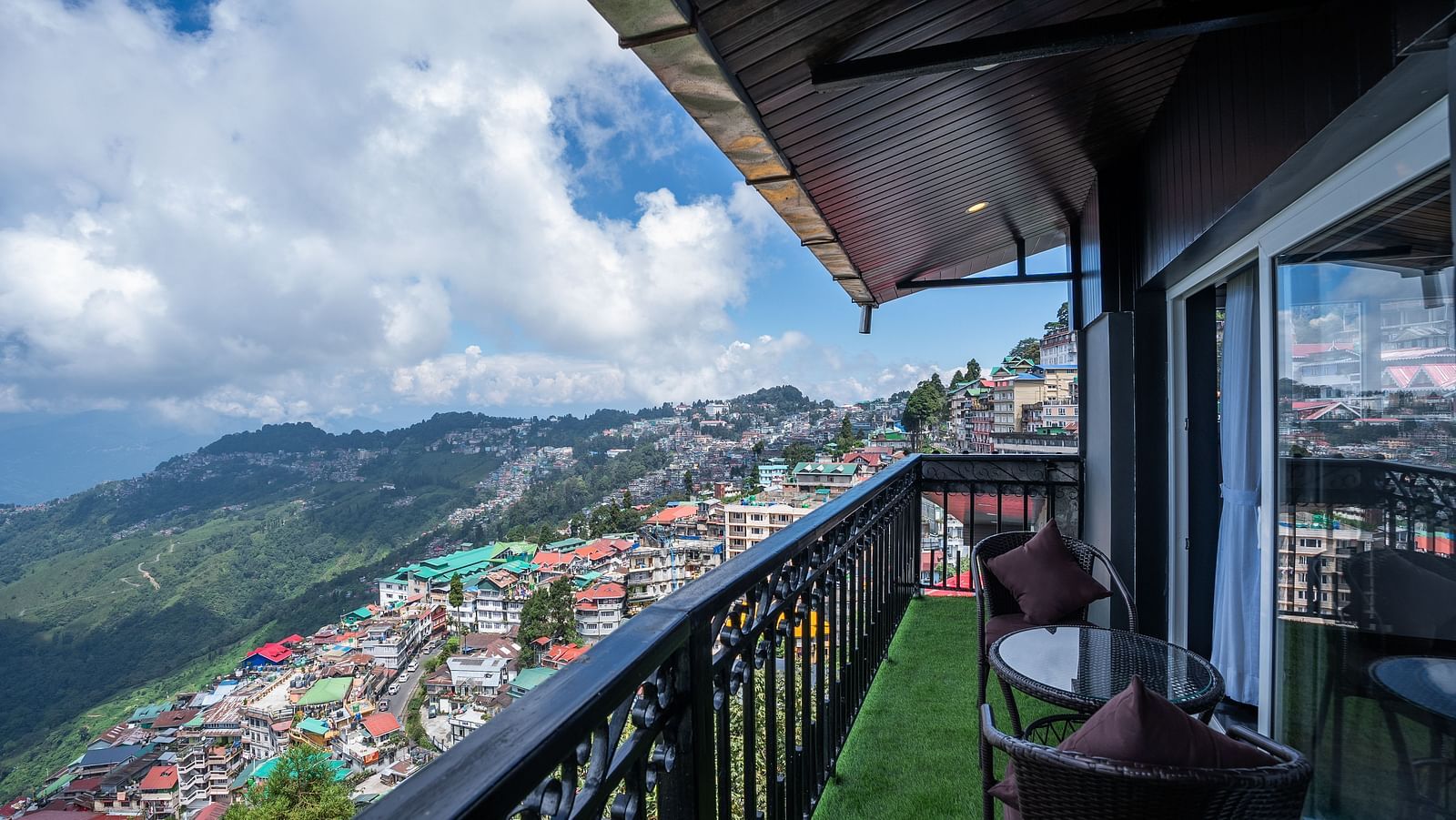 Shot of the private balcony overlooking the surroundings with chairs and table.