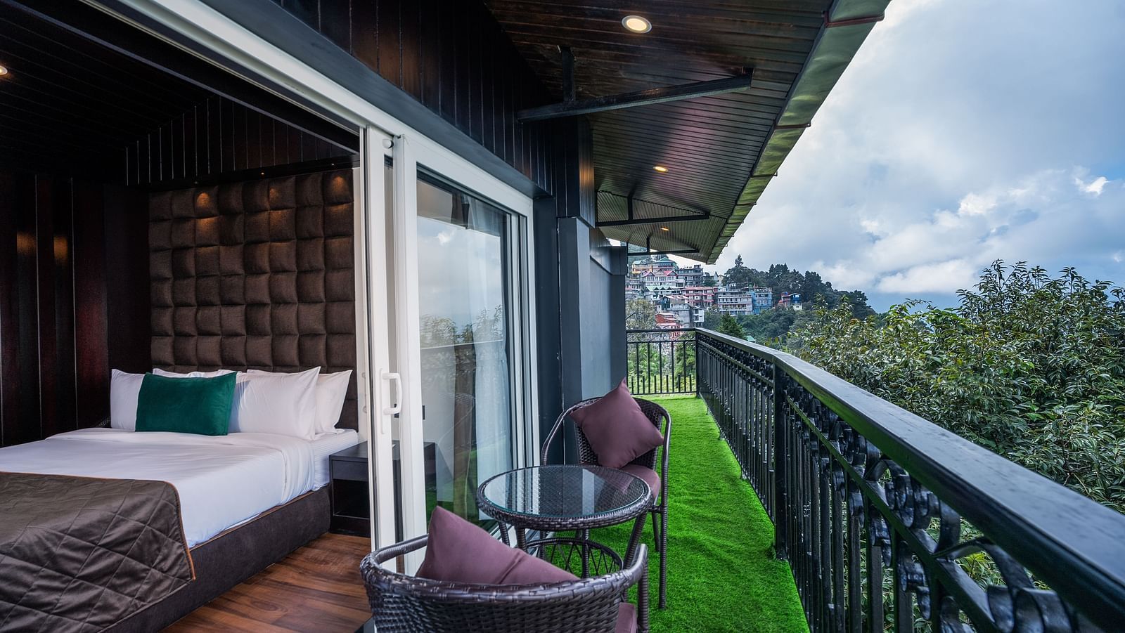 Shot of the private balcony overlooking the surroundings with chairs and table.
